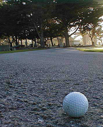 Golf ball in foreground, graves in background